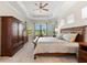 Elegantly furnished bedroom with a comfortable bed, bay windows, and ample natural light at 5637 Arnie Loop, Bradenton, FL 34211