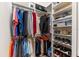 Organized walk-in closet with hanging clothes, shoe racks, and shelving at 5637 Arnie Loop, Bradenton, FL 34211