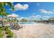 Resort-style community pool with waterfall features, lounge chairs, umbrellas, and lush landscaping for relaxation at 5637 Arnie Loop, Bradenton, FL 34211
