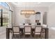 An elegant dining room with a modern light fixture, large windows, and built-in wet bar at 5637 Arnie Loop, Bradenton, FL 34211