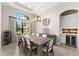 An elegant dining room with a modern light fixture, large windows, and built-in wet bar at 5637 Arnie Loop, Bradenton, FL 34211