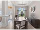 An elegant dining area showcasing a large window, designer lighting, and chic, neutral decor at 5637 Arnie Loop, Bradenton, FL 34211