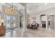 Inviting foyer with decorative glass double doors and adjacent dining area with wine bar at 5637 Arnie Loop, Bradenton, FL 34211