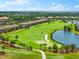 Picturesque golf course view with lush green fairways, manicured landscaping, and beautiful surrounding homes at 5637 Arnie Loop, Bradenton, FL 34211