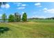 Scenic view of a well-maintained green space with a pond and golf course in the background at 5637 Arnie Loop, Bradenton, FL 34211