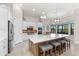 Bright kitchen with a large island, seating, stainless steel appliances, and pendant lights at 5637 Arnie Loop, Bradenton, FL 34211