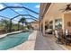A covered lanai with a seating area and a dining area overlooks the pool and is perfect for relaxing and entertaining at 5637 Arnie Loop, Bradenton, FL 34211