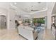 A naturally lit living room features tile flooring, neutral décor, and an open floor plan at 5637 Arnie Loop, Bradenton, FL 34211