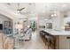 Open concept living room with high ceilings, fan, tile floors and a view of the kitchen at 5637 Arnie Loop, Bradenton, FL 34211