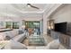 Comfortable living room with tray ceilings and sliding glass doors to the lanai at 5637 Arnie Loop, Bradenton, FL 34211