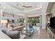 A naturally lit living room features tile flooring, neutral décor, and an open floor plan at 5637 Arnie Loop, Bradenton, FL 34211