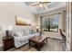 Comfortable living room with modern decor and a view of the outdoors through a large window at 5637 Arnie Loop, Bradenton, FL 34211