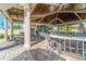 Stylish outdoor bar area with covered seating, ceiling fans, and a spacious countertop for social gatherings at 5637 Arnie Loop, Bradenton, FL 34211
