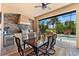 Screened-in outdoor kitchen with stainless steel appliances, stone accent wall and dining area overlooking the pool at 5637 Arnie Loop, Bradenton, FL 34211