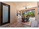 Outdoor kitchen and dining area with brick feature and full view of the outdoor pool at 5637 Arnie Loop, Bradenton, FL 34211