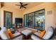 Cozy outdoor patio with ceiling fan and comfortable seating and clear view of the interior living room at 5637 Arnie Loop, Bradenton, FL 34211