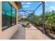 View of the screened-in pool and outdoor space, showing a comfortable lounge chair at 5637 Arnie Loop, Bradenton, FL 34211