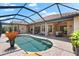 The lanai features a beautiful pool, screened-in enclosure, covered seating area and access to the outdoor kitchen at 5637 Arnie Loop, Bradenton, FL 34211