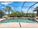 Enjoy the large screened in pool and spa with lush tropical landscaping and beautiful views of the surrounding area at 5637 Arnie Loop, Bradenton, FL 34211