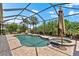 Enjoy the sun in the large backyard pool and spa surrounded by tropical landscaping and a screened enclosure at 5637 Arnie Loop, Bradenton, FL 34211