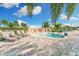 Relaxing spa pool area featuring stone waterfall, lounge chairs, and palm trees in a serene outdoor setting at 5637 Arnie Loop, Bradenton, FL 34211