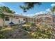 Backyard with garden beds and view of the home with an enclosed pool at 5728 Whistlewood Cir, Sarasota, FL 34232