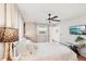 Cozy bedroom features hardwood floors, ceiling fan, and bright natural light at 5728 Whistlewood Cir, Sarasota, FL 34232