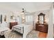 Charming bedroom with hardwood floors, ceiling fan, and vintage furniture at 5728 Whistlewood Cir, Sarasota, FL 34232