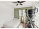 Bright bedroom featuring hardwood floors, ceiling fan, and a Sole fitness machine at 5728 Whistlewood Cir, Sarasota, FL 34232