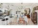 Open concept dining area showcases chandelier, bar seating, and view to the living room at 5728 Whistlewood Cir, Sarasota, FL 34232