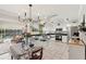 Bright kitchen and dining area with stainless steel appliances and seamless flow to outdoor living space at 5728 Whistlewood Cir, Sarasota, FL 34232