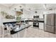 Modern kitchen features stainless appliances, tile backsplash, and island with bar seating at 5728 Whistlewood Cir, Sarasota, FL 34232