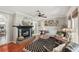 Inviting living room featuring a fireplace, hardwood floors, and stylish decor at 5728 Whistlewood Cir, Sarasota, FL 34232