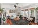 Bright living room with hardwood floors, a fireplace, and large windows at 5728 Whistlewood Cir, Sarasota, FL 34232