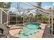 Screened-in pool and spa surrounded by a brick patio at 5728 Whistlewood Cir, Sarasota, FL 34232