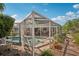Enclosed pool and patio area features a brick surround and landscaping at 5728 Whistlewood Cir, Sarasota, FL 34232