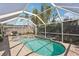 Screened-in pool and spa surrounded by a brick patio at 5728 Whistlewood Cir, Sarasota, FL 34232