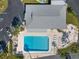 An aerial view of the community pool with lounge chairs and parking in a well landscaped setting at 6087 Coral Way, Bradenton, FL 34207