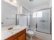 Bathroom with glass shower door, tile flooring, and wood vanity at 6087 Coral Way, Bradenton, FL 34207