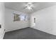 Bedroom with neutral carpet, window, ceiling fan and white walls at 6087 Coral Way, Bradenton, FL 34207