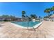 Sparkling community pool with ample lounge seating, set against a backdrop of lush palm trees at 6087 Coral Way, Bradenton, FL 34207