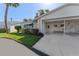 A single-story home boasts a carport and awning-covered window, complemented by the lush front yard and a sunny, welcoming ambiance at 6087 Coral Way, Bradenton, FL 34207