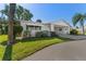 Charming single-story home featuring a well-manicured lawn, carport, and a beautifully maintained front yard with mature landscaping at 6087 Coral Way, Bradenton, FL 34207