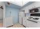 Kitchen featuring tiled flooring, appliances, and white cabinetry and countertops at 6087 Coral Way, Bradenton, FL 34207