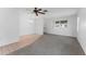 Neutral living space offers carpet, tile flooring, a ceiling fan, and natural light creating an inviting and versatile atmosphere at 6087 Coral Way, Bradenton, FL 34207