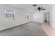 Bright living room features neutral carpet, a ceiling fan, and ample natural light through two windows for a warm atmosphere at 6087 Coral Way, Bradenton, FL 34207
