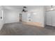 Neutral interior shows transition from carpet to tile, ceiling fan, and a hallway, creating a seamless blend of comfort and accessibility at 6087 Coral Way, Bradenton, FL 34207