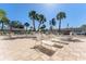 Community pool featuring lounge chairs for relaxing under the palm trees on a sunny day at 6087 Coral Way, Bradenton, FL 34207