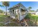 The exterior of the home features a screen enclosed lanai with a beautifully maintained yard at 6087 Coral Way, Bradenton, FL 34207