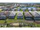An aerial view of a charming neighborhood featuring beautiful homes, lush landscaping, and a tranquil pond at 6228 Champions Row St, Bradenton, FL 34210